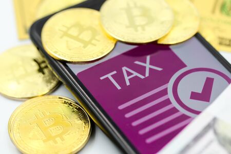 Bitcoin Crypto Currency with TAX message and dollars money, Determining the tax law of digital money Conceptの写真素材