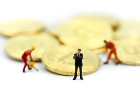 Miniature people : miner Worker Man  digging Bitcoin on whiteの写真素材