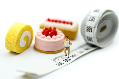 Miniature people : marathon runners with measuring tape of Sweet dessert, jogging and running, Active and healthy lifestyle concept.の写真素材