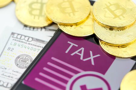 Bitcoin Crypto Currency with TAX message and dollars money, Determining the tax law of digital money Conceptの写真素材