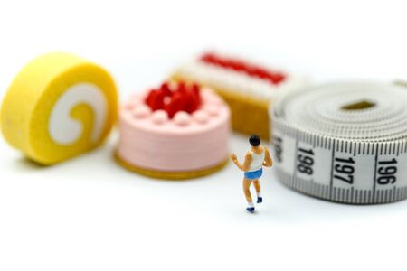 Miniature people : marathon runners with measuring tape of Sweet dessert, jogging and running, Active and healthy lifestyle concept.の写真素材