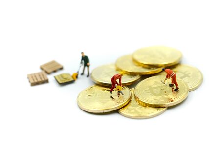 Miniature people : miner Worker Man  digging Bitcoin on whiteの写真素材