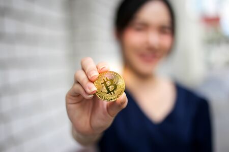Selective of focus with Businesswoman holding the bitcoin gold coinの写真素材