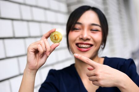 Selective of focus with Businesswoman holding the bitcoin gold coinの写真素材