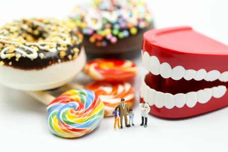 Miniature people : Doctor dentist speaks about student and children with dessertの写真素材