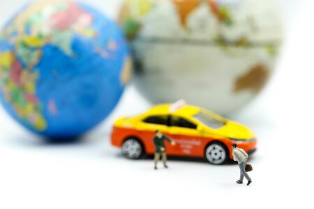 Miniature people : businessman and Traveler backpacking Calling Taxi, business Travel concept.の写真素材