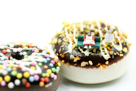 Miniature people : Fat old man sitting on tape Measure with junk food, Healthcare and diet concept.の写真素材