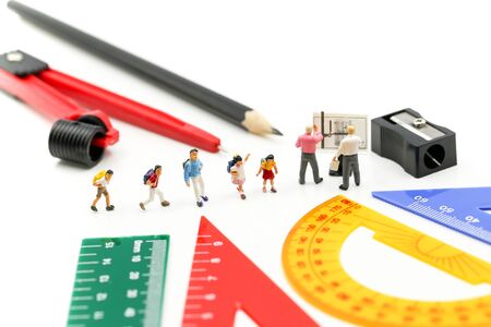 Miniature people : teacher and student with Group of stationery tools Educational tools supplies back to school concept.の写真素材