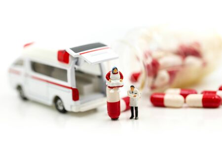 Miniature people : Doctor with patient in medical office with worker take Pill capsules, Health care concept.の写真素材