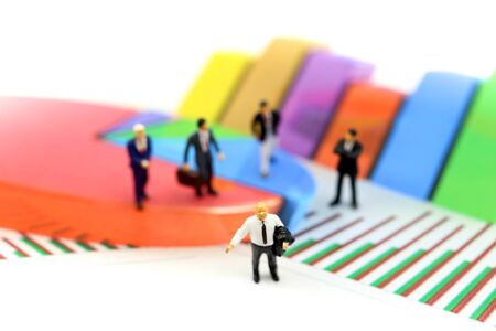 Miniature people : Successful businessman with Paper graph chart ,Business Growth concept.の写真素材