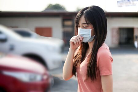 Beautiful asia  Woman suffer from sick and wearing face mask  protect filter against air pollution (PM2.5),Air pollution caused health problem,anti smog and virusesの写真素材