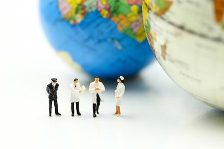 Miniature people : Doctor team with global world, scientist in biological protective Epidemic virus outbreak coronavirusの写真素材