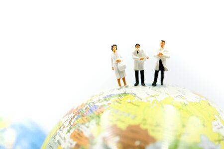 Miniature people : Doctor team with global world, scientist in biological protective Epidemic virus outbreak coronavirusの写真素材