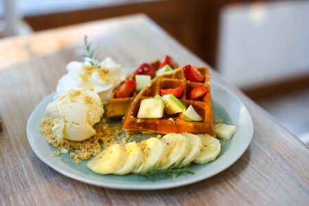 Waffle of fresh berries strawberry, blueberry, bananas and chocolate toppingの写真素材