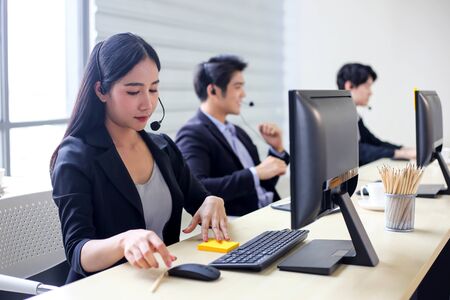 Asia Group of call center workers or Confident business team with headset in office.の写真素材