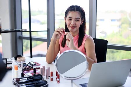 Asian woman beauty blogger review cosmetic product Online influencer girl social media marketing.の写真素材