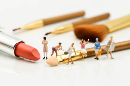 Miniature people : beautiful woman and Makeup products with cosmetic