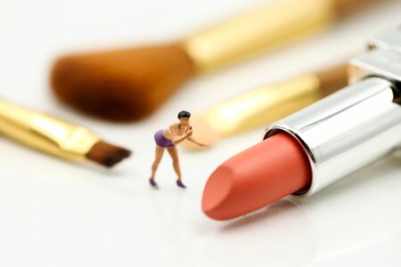 Miniature people : beautiful woman and Makeup products with cosmeticの写真素材