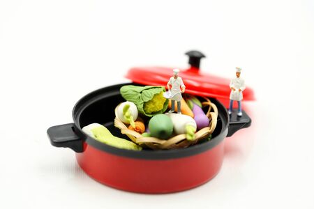 Miniature people : Chef cooking fresh vegetables in a potの写真素材