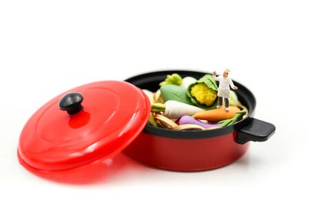 Miniature people : Chef cooking fresh vegetables in a potの写真素材