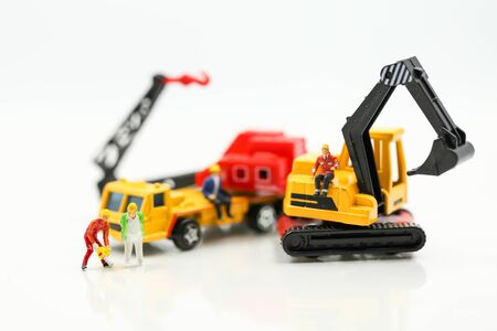 Miniature people : Group of worker and Engineer in a construction site with digger Tractorの写真素材