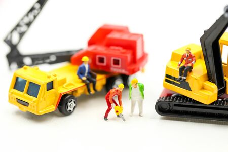 Miniature people : Group of worker and Engineer in a construction site with digger Tractorの写真素材