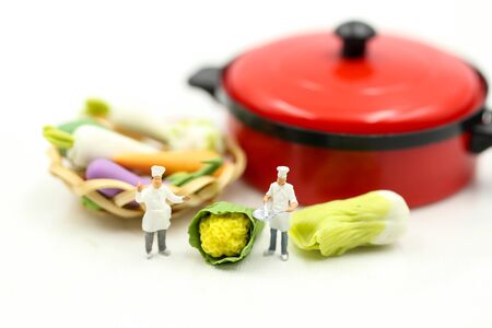 Miniature people : Chef cooking fresh vegetables in a potの写真素材