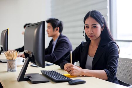 Asia Group of call center workers or Confident business team with headset in office.の写真素材