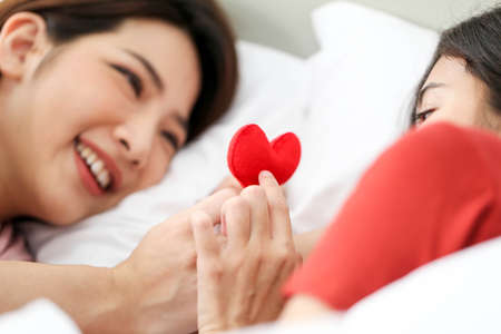 Couple love lesbian happy couple waking up in morning,LGBT Lesbian couple together indoors concept.の写真素材