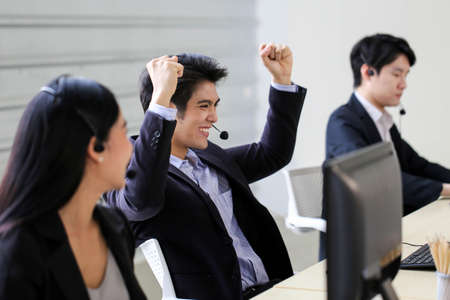 Asia Group of call center workers or Confident business team with headset in office.の写真素材