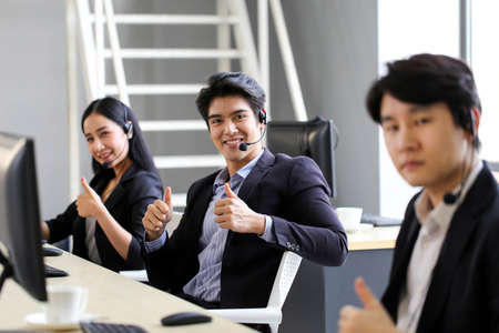 Asia Group of call center workers or Confident business team with headset in office.の写真素材