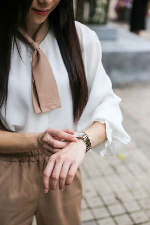 Beautiful woman looking at her watch.