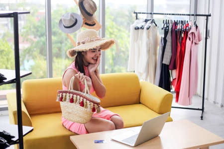 Asian woman beauty blogger or vlogger review  in clothing store,Online influencer girl social media marketing.の写真素材