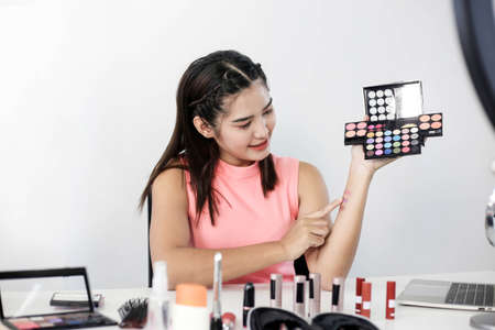 Asian woman beauty blogger or vlogger review cosmetic product Online influencer girl social media marketing.の写真素材