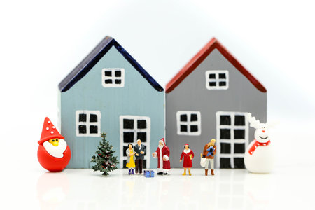 Merry christmas and happy new year Miniature People : Children with Santa Claus doll and his reindeer isolated on white background,in Christmas festival.の写真素材
