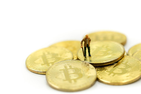 Miniature people : Businessman with Cryptocurrency Bitcoin coins virtual money and dollars,will growth up in the future bitcoin investmentの写真素材
