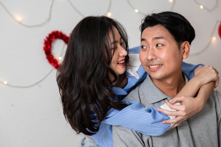 Couple in love hugging in the bedroom with rose and gift Valentine's Day  concept.