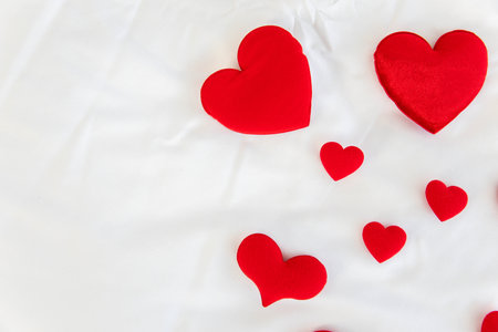 Heart shape with Gift box packed for honeymoon lover on white bed honeymoon suit.Valentine's day concept. Beautiful blurry background.heart lay on the bed.の写真素材