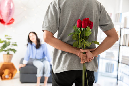 loving couple  Man with rose and gift on back in bedroom valentines day concept.の写真素材