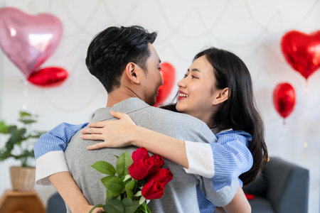 Couple in love hugging in the bedroom with rose and gift Valentine's Day  concept.の写真素材