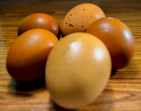 Five eggs bubbles lie on the wooden floor with a beautiful patternの写真素材