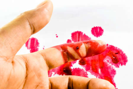 Blood on finger on white backgroundの写真素材