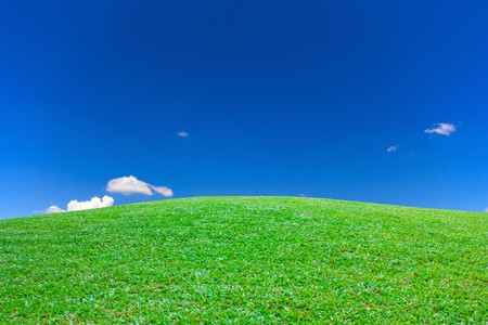 Green grass mountain clear sky viewの写真素材