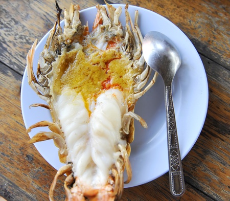 Giant lobster grilled compared size with spoonの写真素材