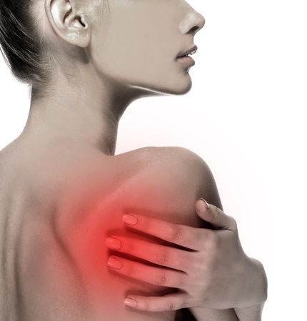 Closeup of young woman suffering on a back pain problemの写真素材