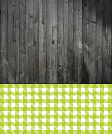 Dark grey wooden background with checkered Tablecloth greenの写真素材