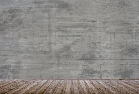 Empty room with old dark grey concrete grunge wall with brown wooden planksの写真素材