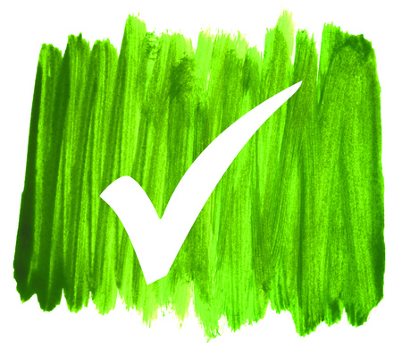 Tick symbol on sketch of dirty green hand drawn strokesの写真素材