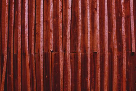 Rustic red wooden wall with old weathered planksの写真素材