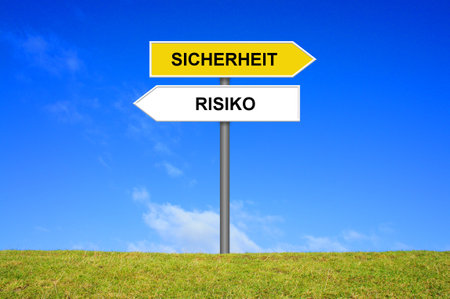 Signpost outside is showing Safety or Risk in german languageの写真素材